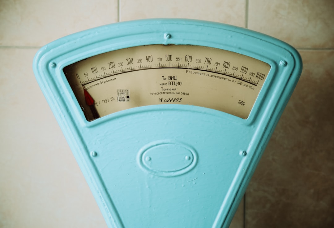 A bathroom scale viewed from a low angle on tiled flooring — the kind that doesn't tell you anything yet.